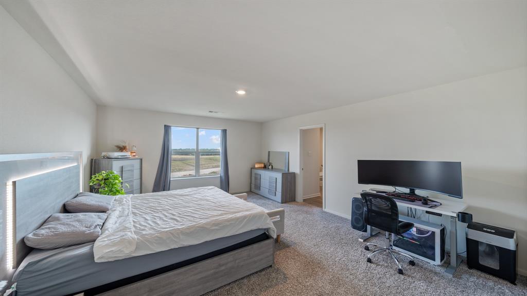 408 Micah Lane Ferris, TX 75125 - Photo 7 of 19 a bedroom with a bed and a flat screen tv