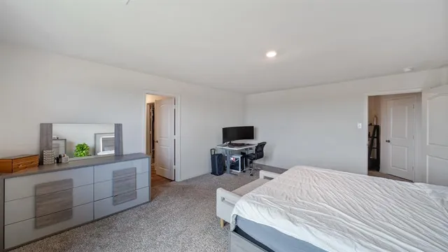a bedroom with a bed and a desk