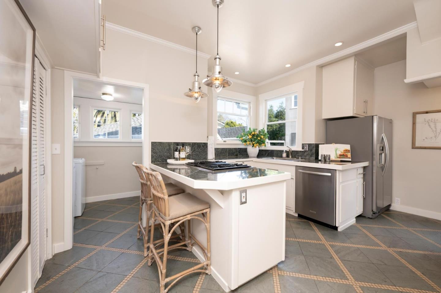 344 Occidental Avenue Burlingame, CA 94010 - Photo 11 of 27 a kitchen with a sink a stove a refrigerator and white cabinets