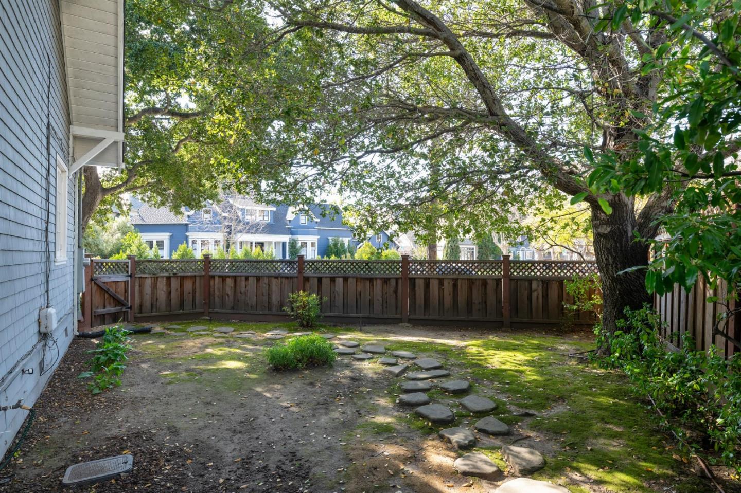 344 Occidental Avenue Burlingame, CA 94010 - Photo 22 of 27 a view of a backyard with a large tree and wooden fence