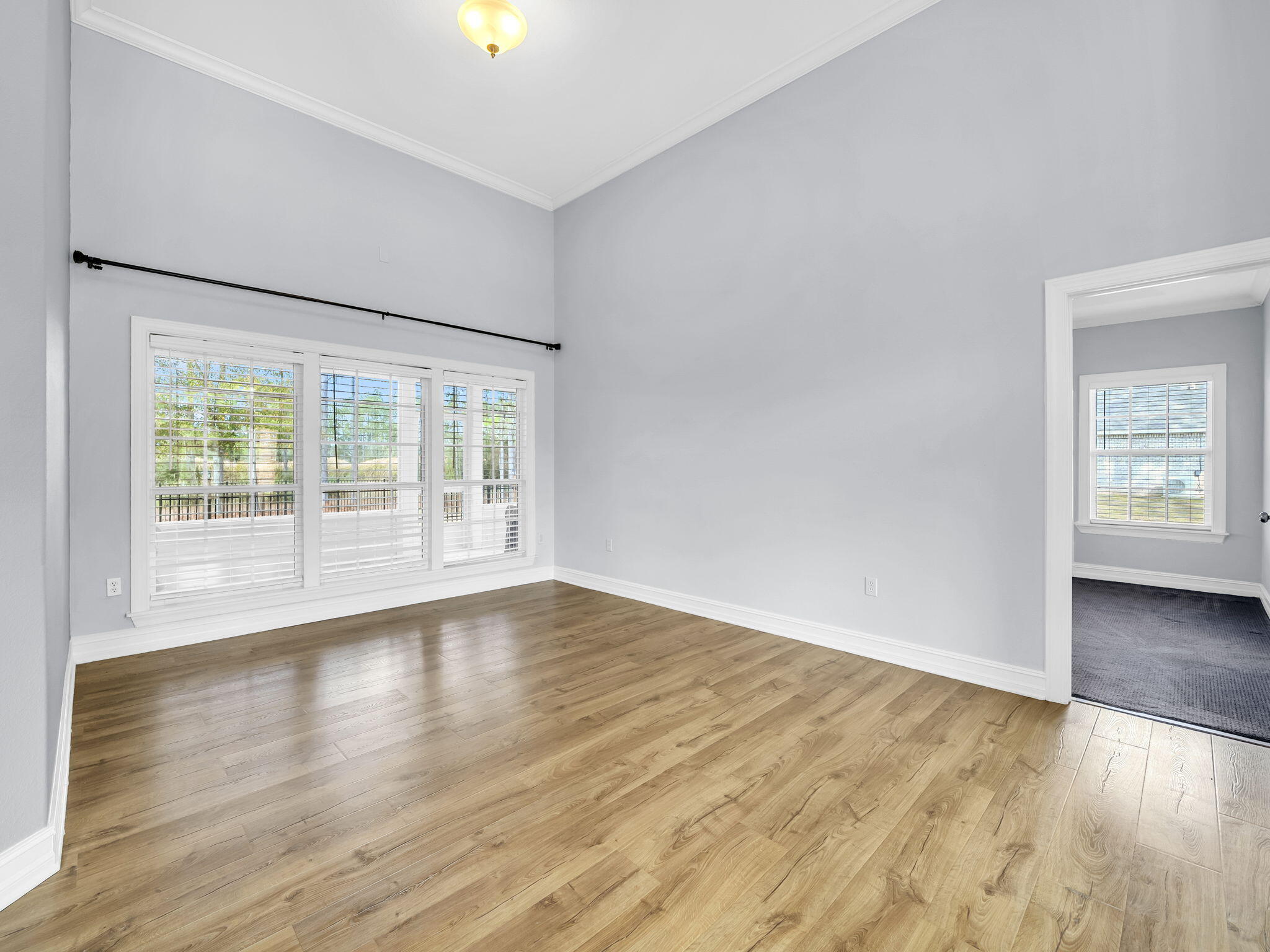 180 Gulf Pines Court Freeport, FL 32439 - Photo 12 of 70 a view of an empty room with wooden floor and a window