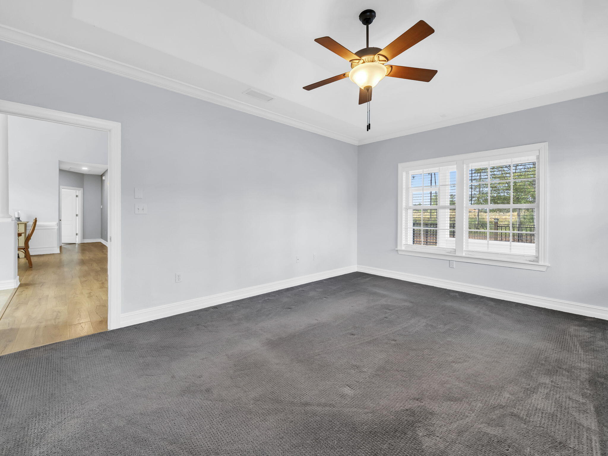 180 Gulf Pines Court Freeport, FL 32439 - Photo 21 of 70 wooden floor in an empty room with a window