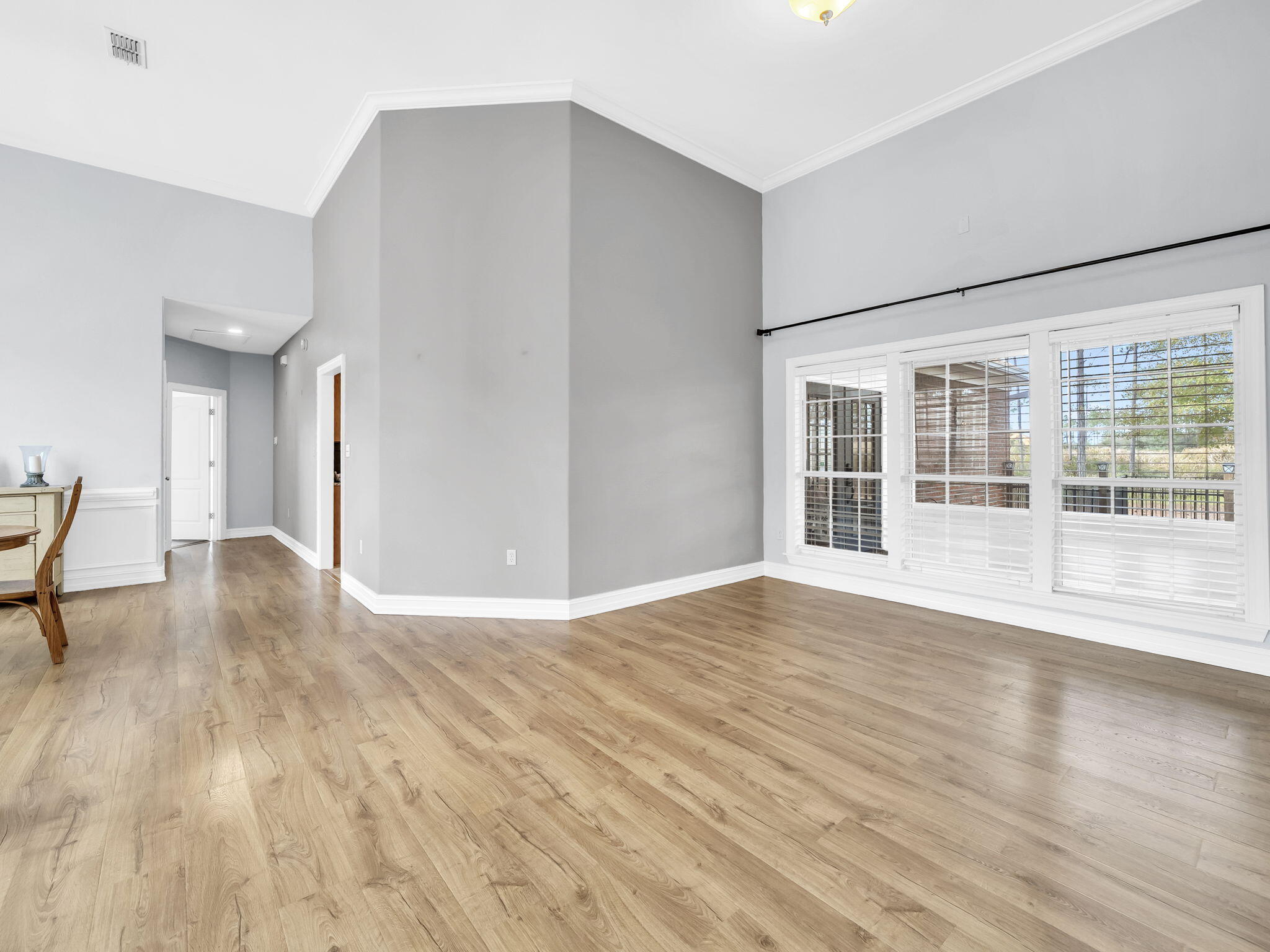 180 Gulf Pines Court Freeport, FL 32439 - Photo 27 of 70 a view of empty room with wooden floor and fan