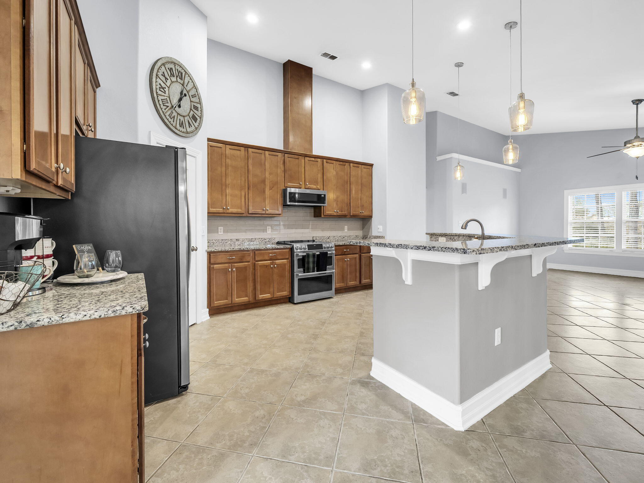 180 Gulf Pines Court Freeport, FL 32439 - Photo 30 of 70 a kitchen with stainless steel appliances granite countertop a stove a sink a refrigerator and a cabinets