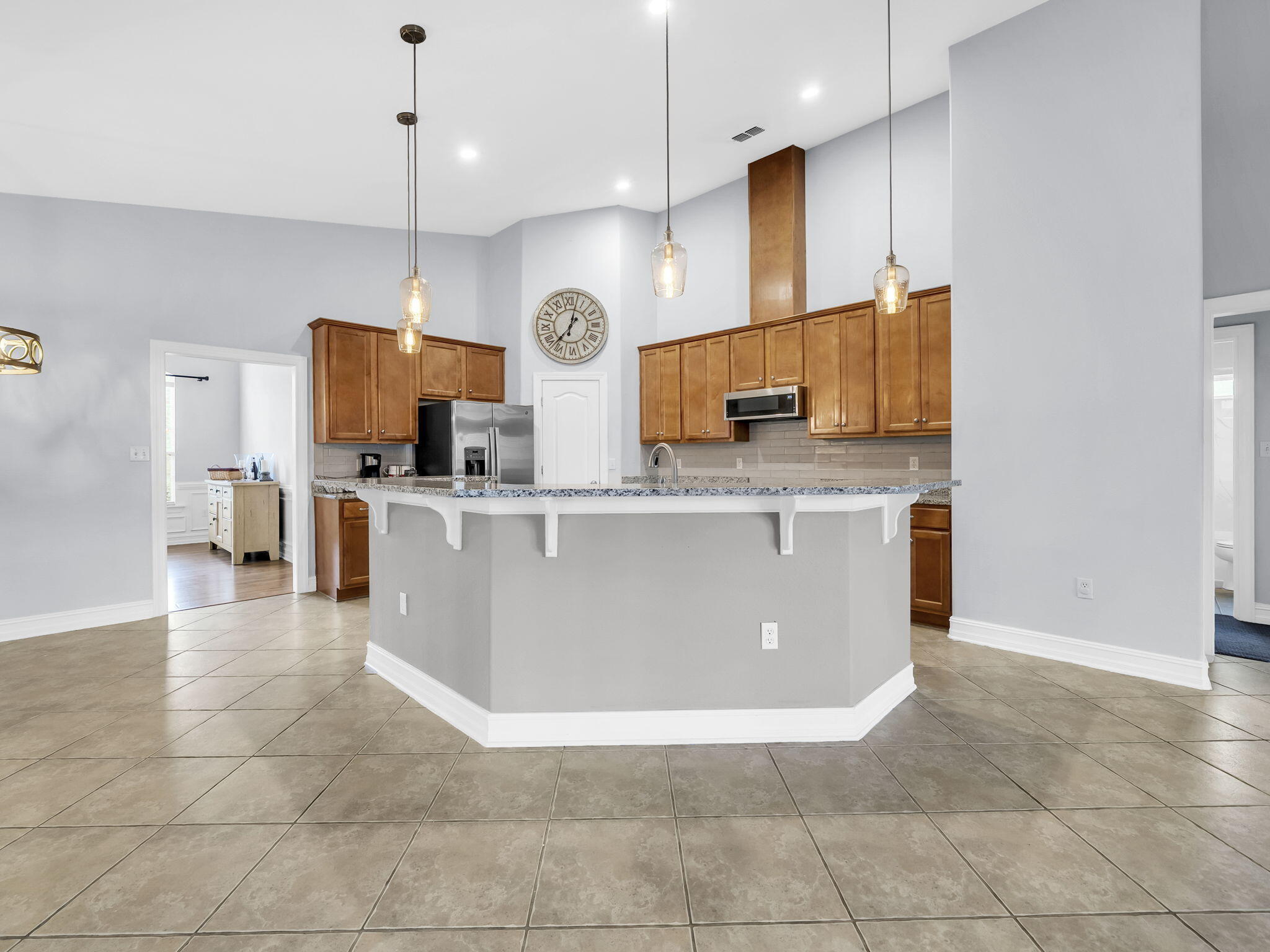 180 Gulf Pines Court Freeport, FL 32439 - Photo 31 of 70 a large kitchen with stainless steel appliances kitchen island granite countertop a stove a sink a microwave and a refrigerator