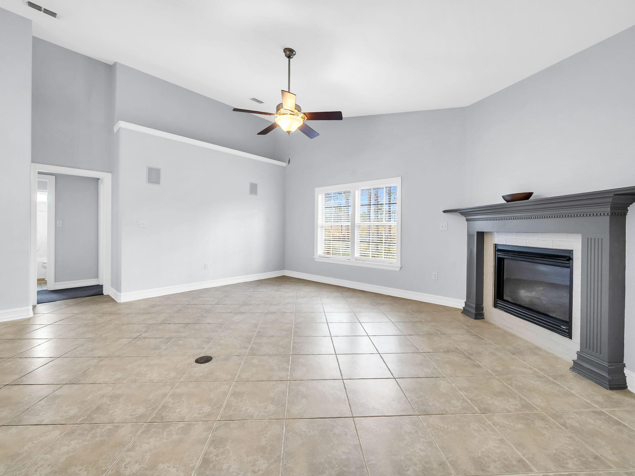 180 Gulf Pines Court Freeport, FL 32439 - Photo 39 of 70 a view of an empty room with a fireplace and a window