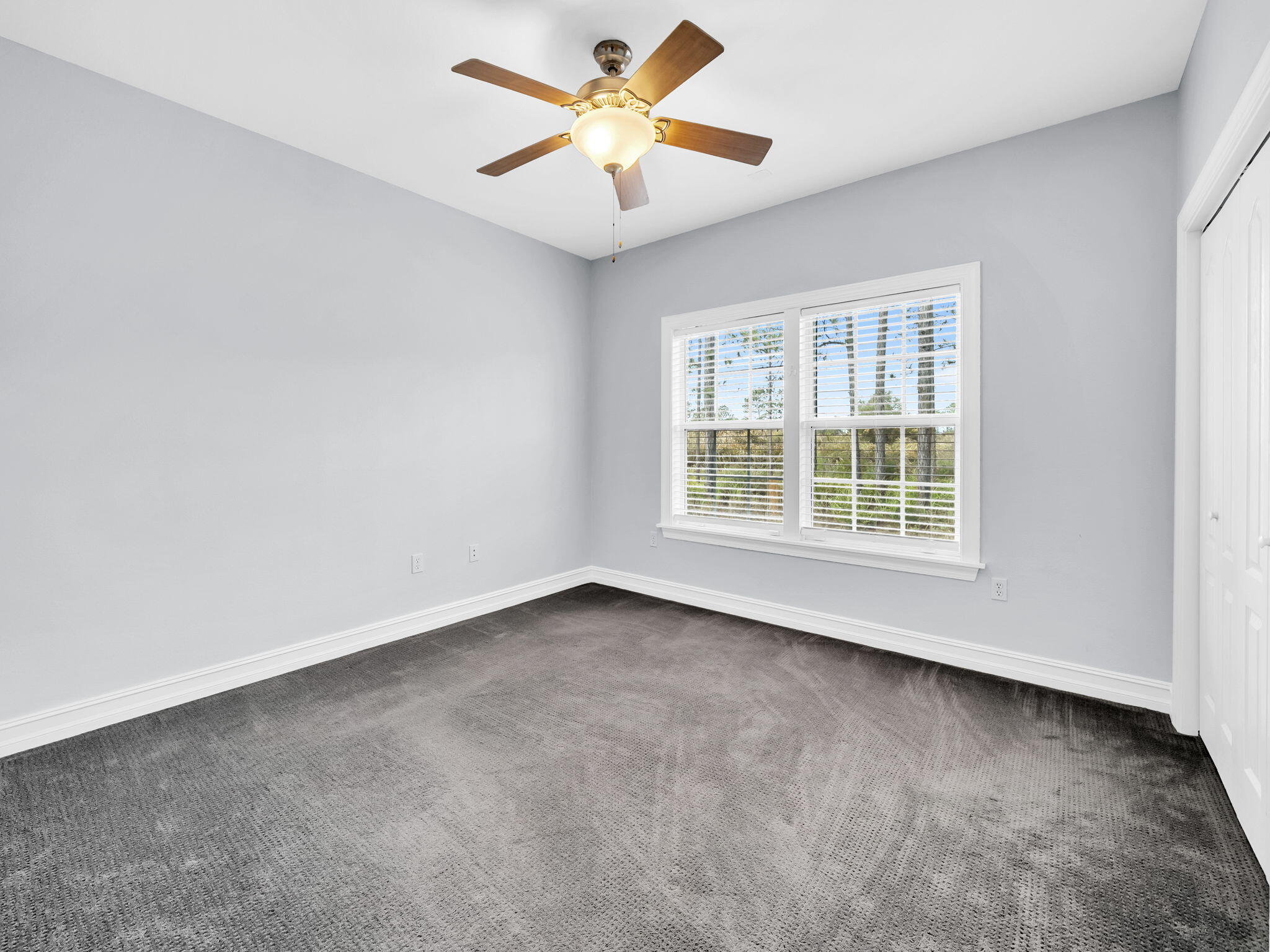 180 Gulf Pines Court Freeport, FL 32439 - Photo 40 of 70 an empty room with a window and a ceiling fan