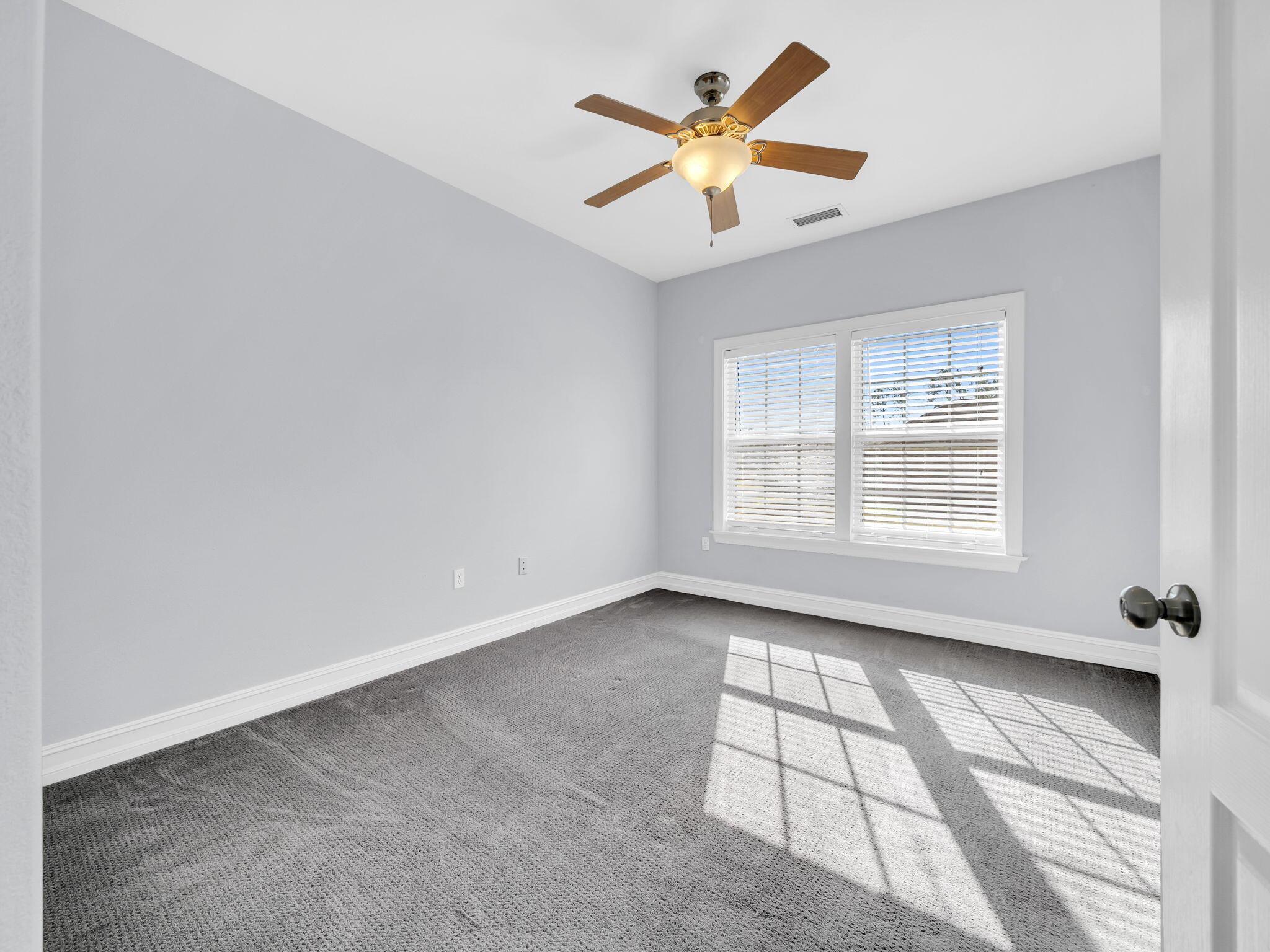 180 Gulf Pines Court Freeport, FL 32439 - Photo 48 of 70 an empty room with a window and a ceiling fan