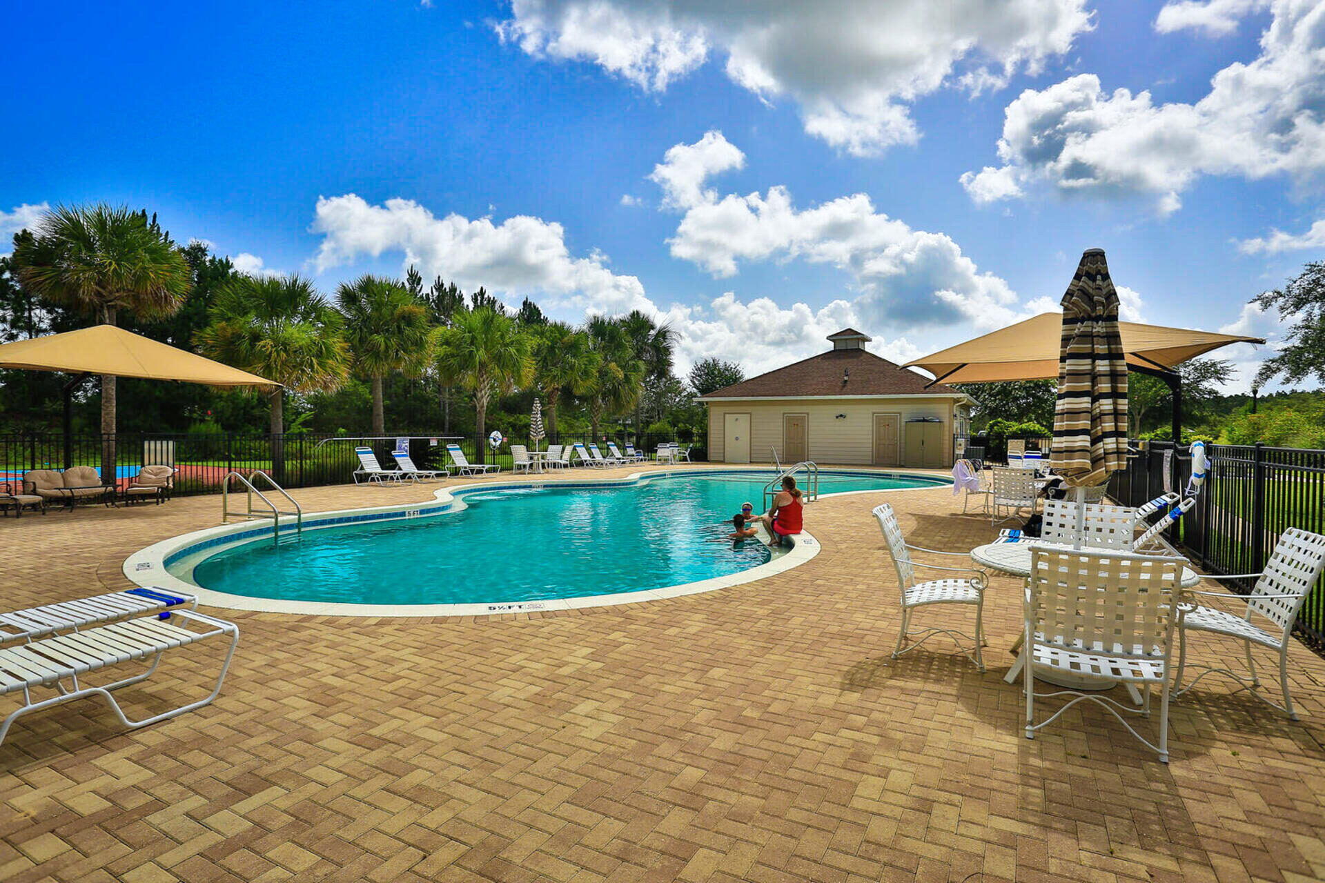 180 Gulf Pines Court Freeport, FL 32439 - Photo 65 of 70 a view of a house with swimming pool and sitting area
