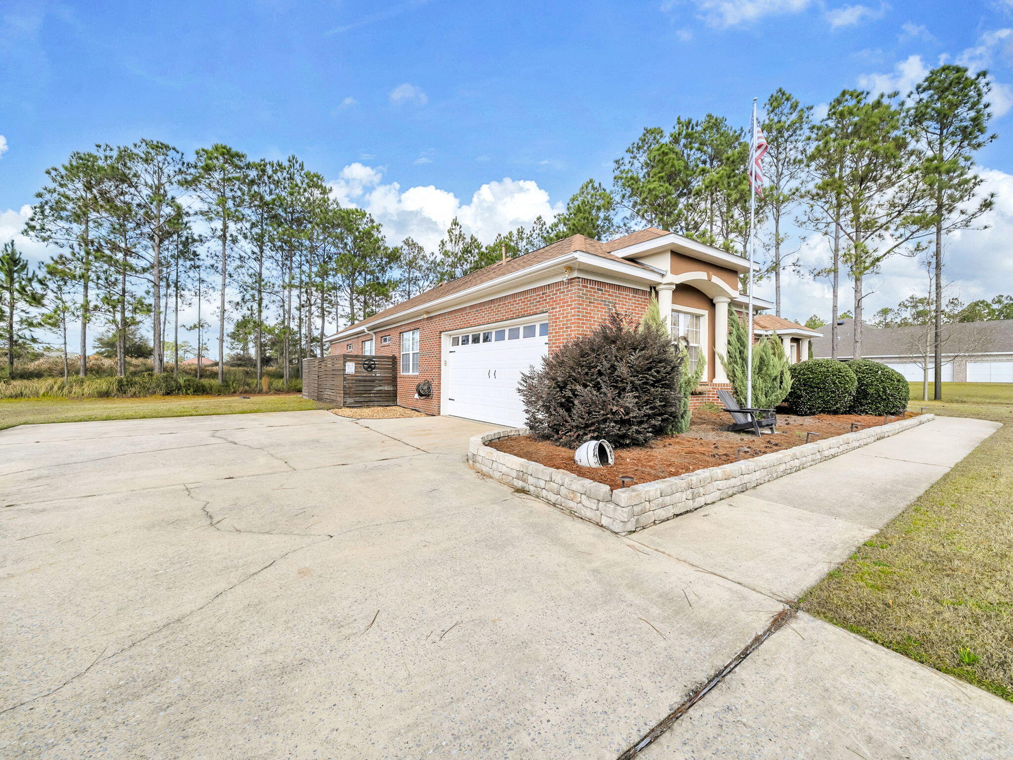 180 Gulf Pines Court Freeport, FL 32439 - Photo 10 of 70 a front view of a house with a yard and potted plants