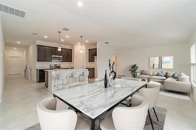 a living room with furniture and kitchen view