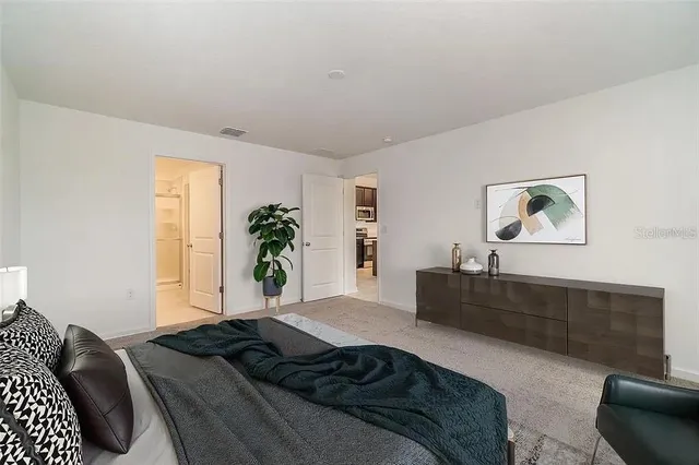 a bedroom with a bed and a couch