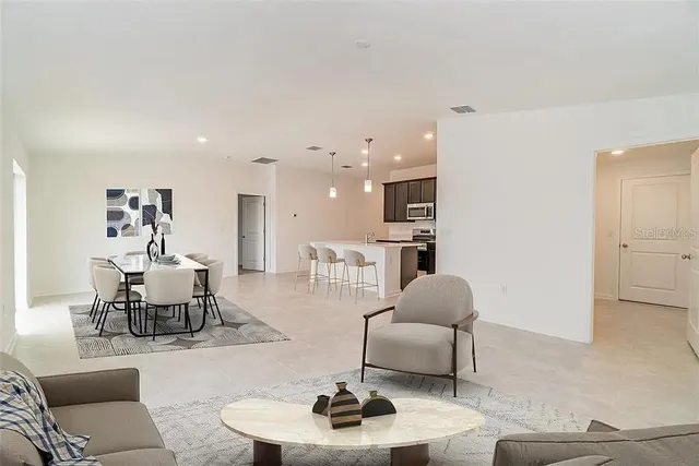 a living room with furniture and a lamp