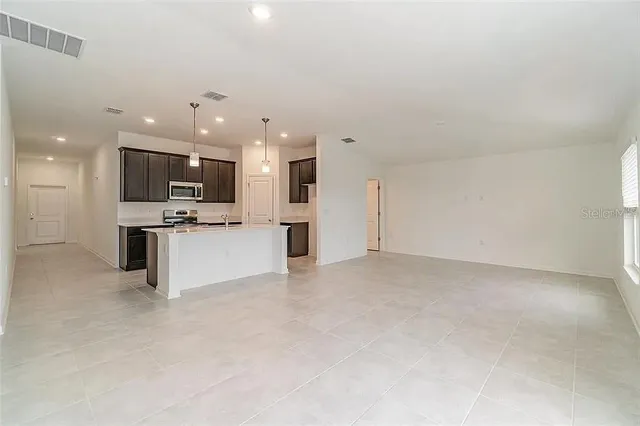 a view of kitchen and kitchen with a sink