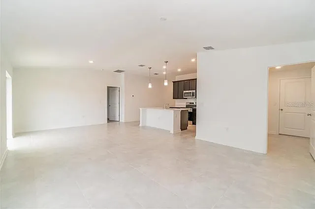 a view of a kitchen with a sink and a refrigerator