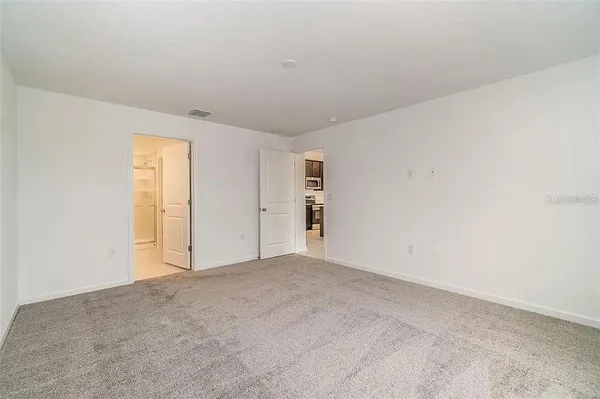 a view of an empty room and a window