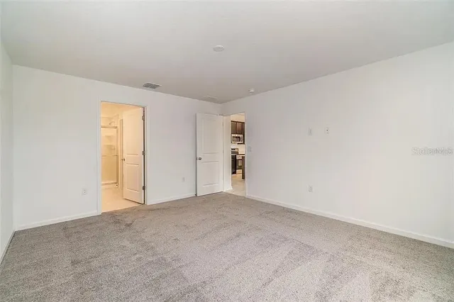 a view of an empty room and a window