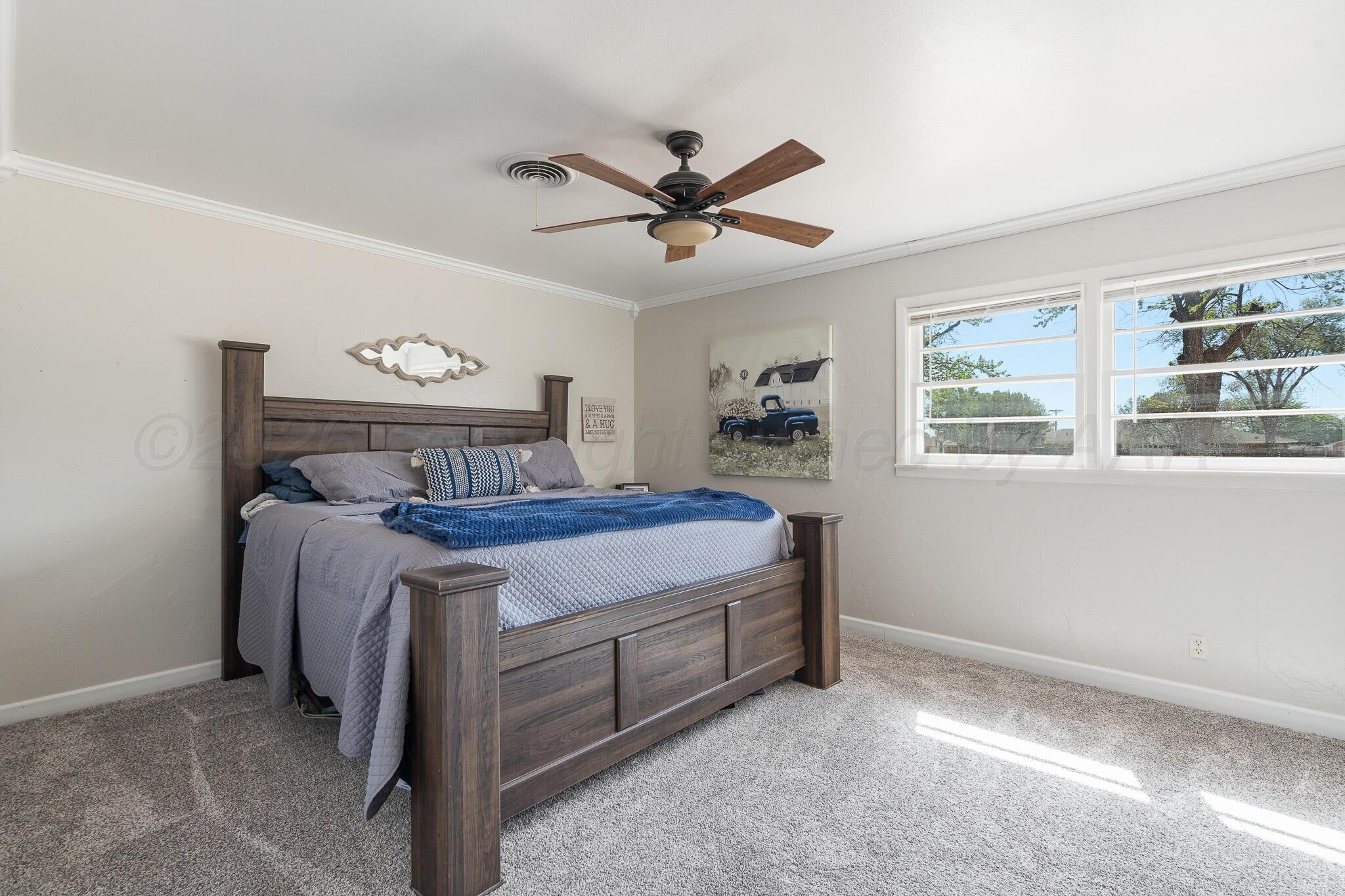 700 West Cleveland Street Dimmitt, TX 79027 - Photo 17 of 40 a spacious bedroom with a bed and a window