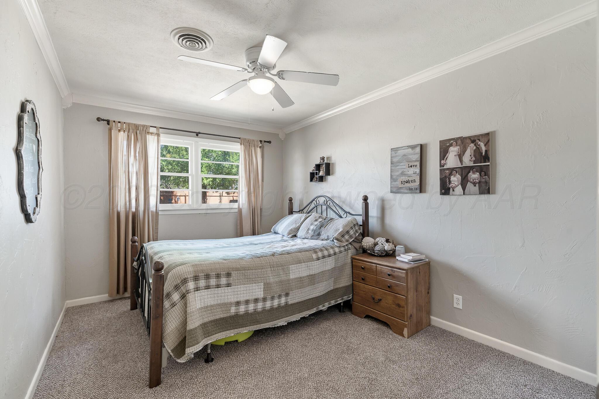 700 West Cleveland Street Dimmitt, TX 79027 - Photo 24 of 40 a bedroom with a bed and a window