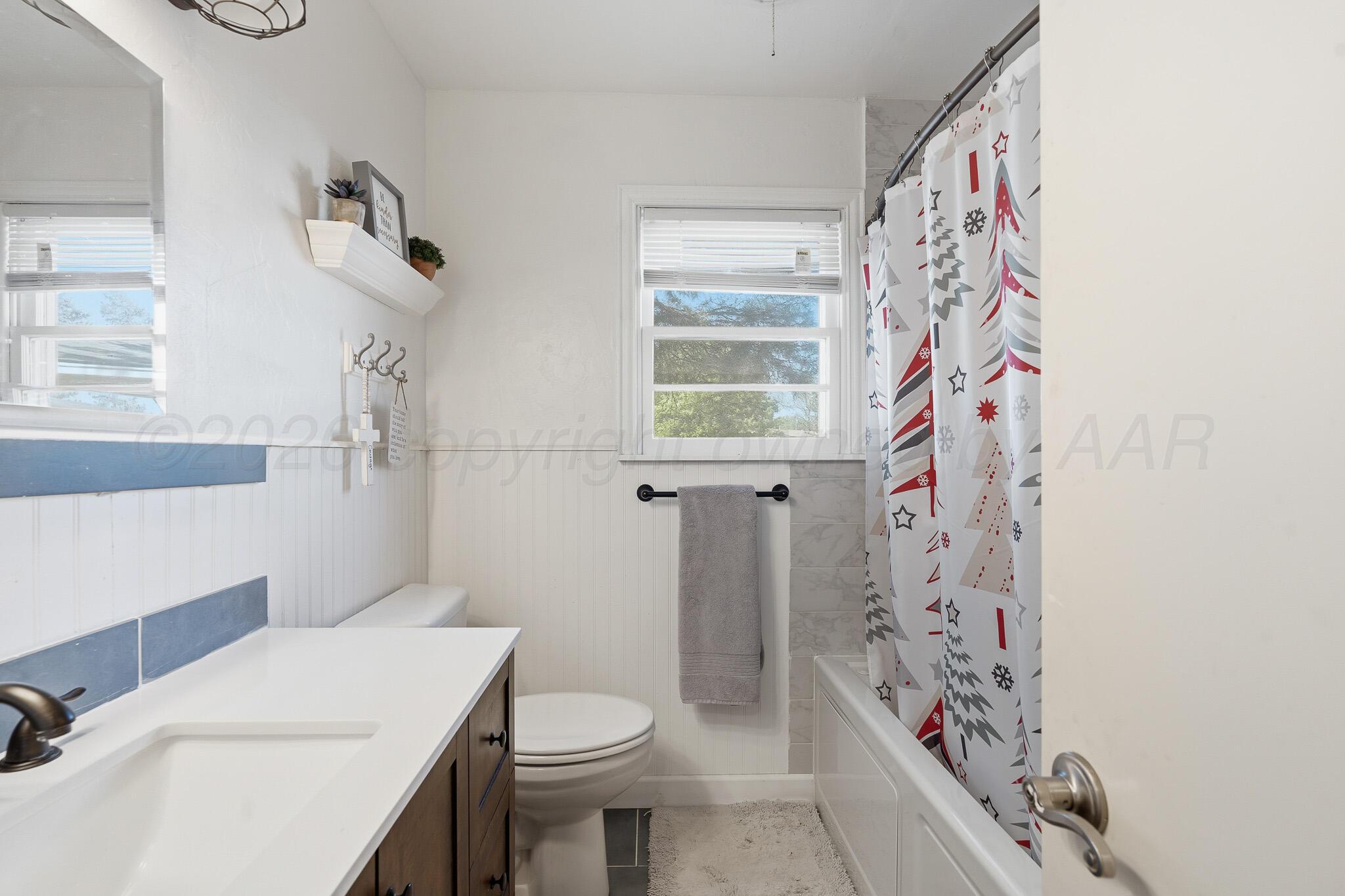 700 West Cleveland Street Dimmitt, TX 79027 - Photo 27 of 40 a bathroom with a sink toilet and shower