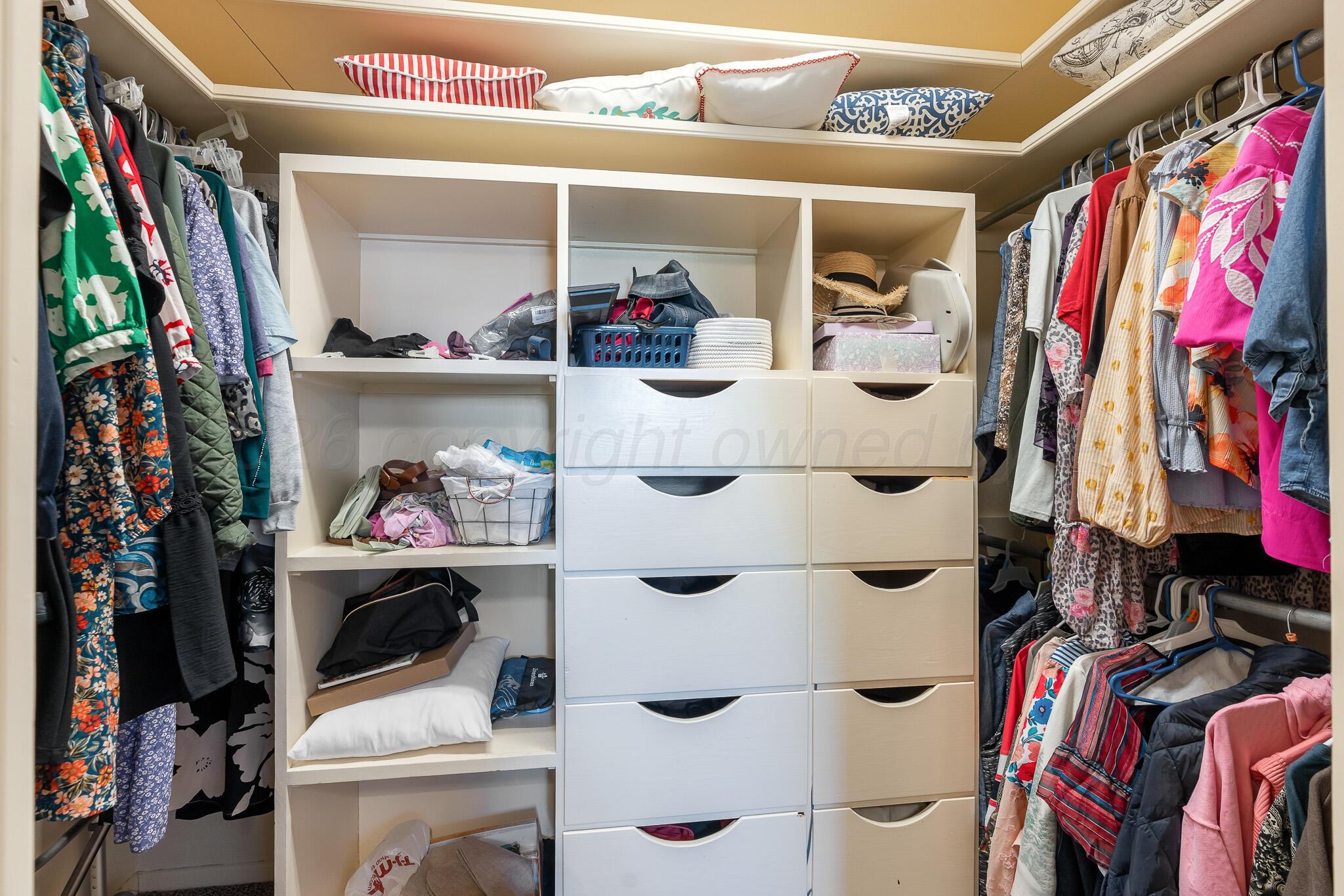 700 West Cleveland Street Dimmitt, TX 79027 - Photo 30 of 40 a view of walk in closet with clothes and shoes