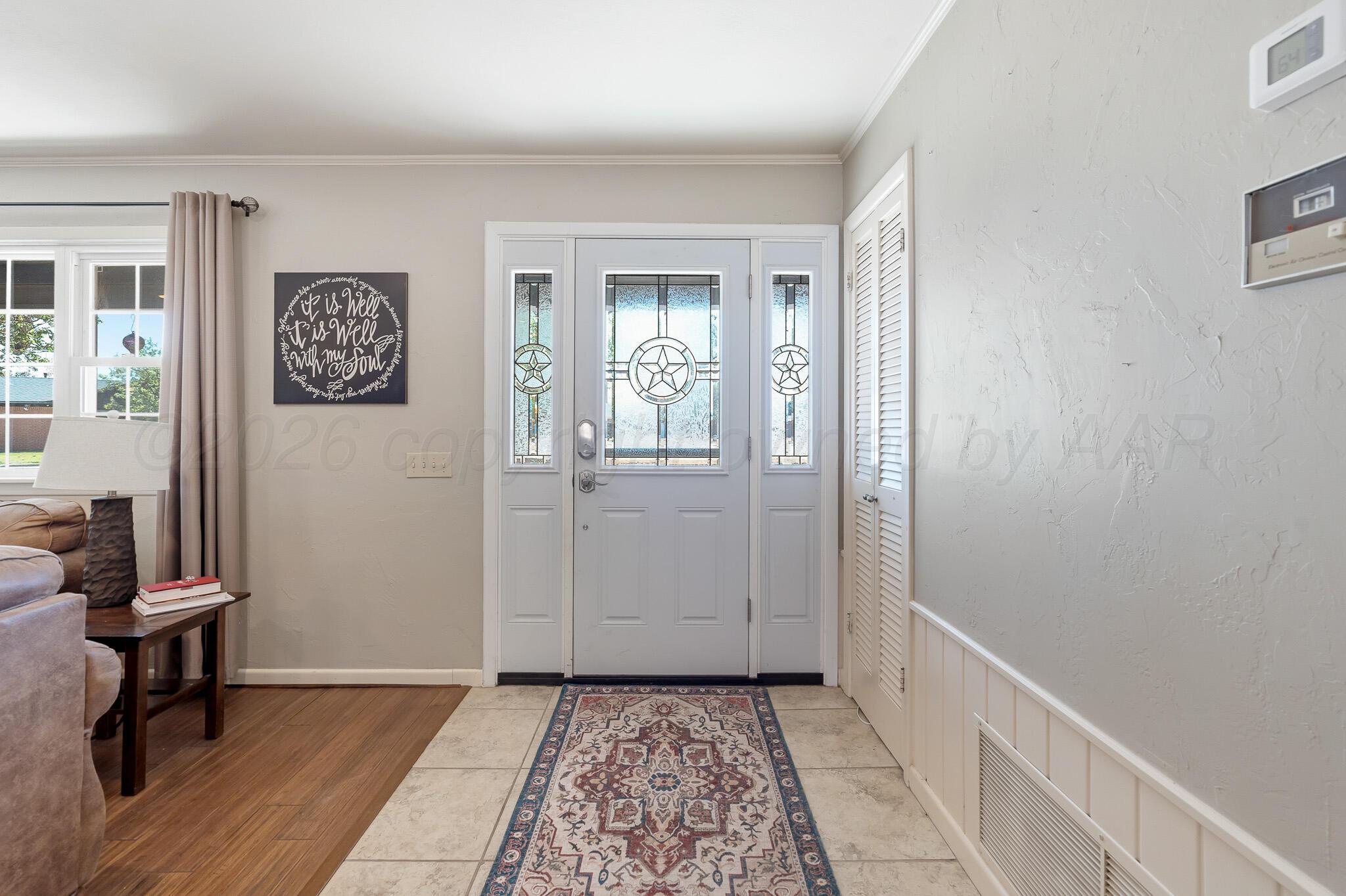700 West Cleveland Street Dimmitt, TX 79027 - Photo 3 of 40 a view of a hallway with a door and a window