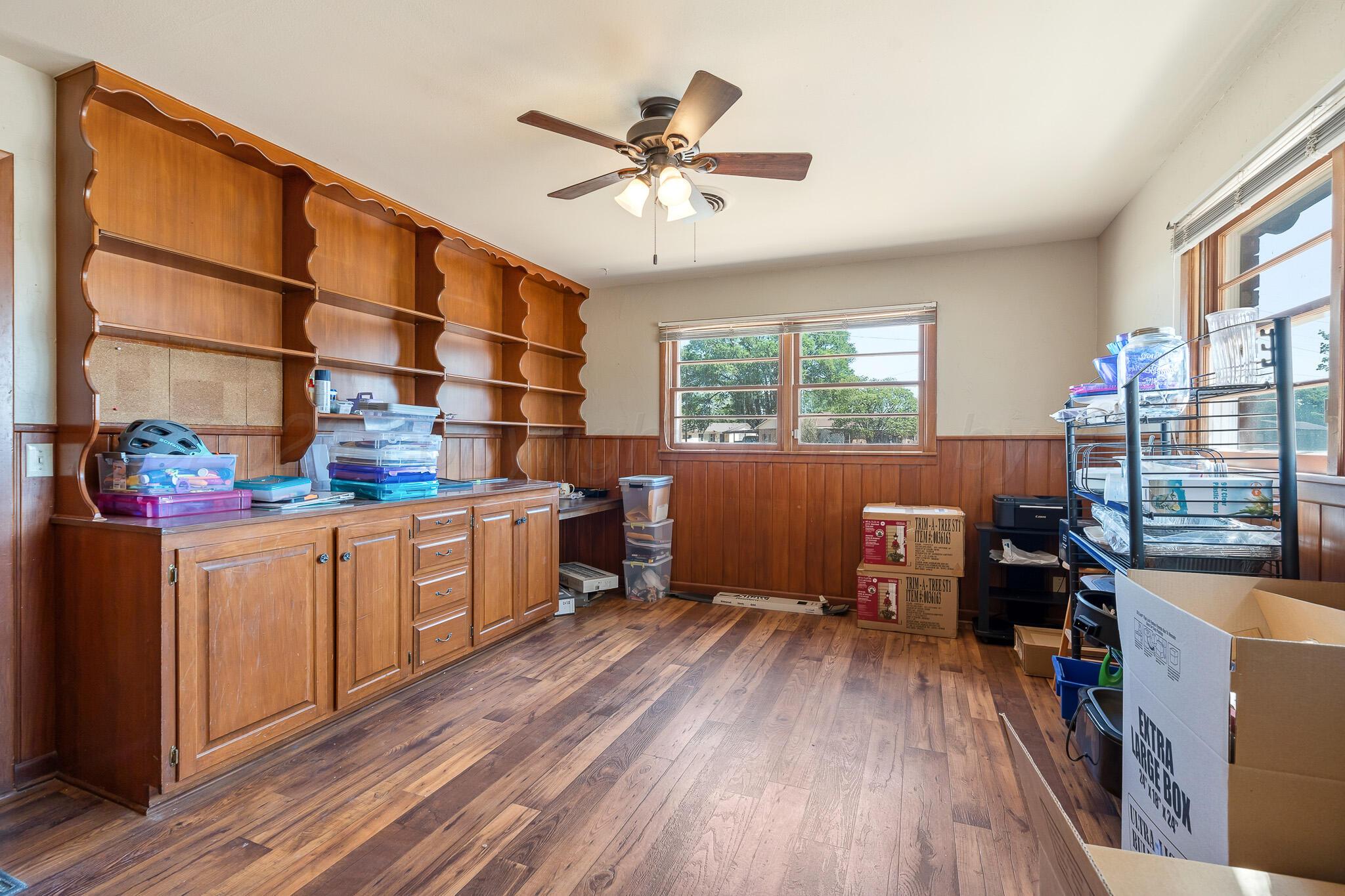 700 West Cleveland Street Dimmitt, TX 79027 - Photo 31 of 40 a view of workspace with wooden floor and windows