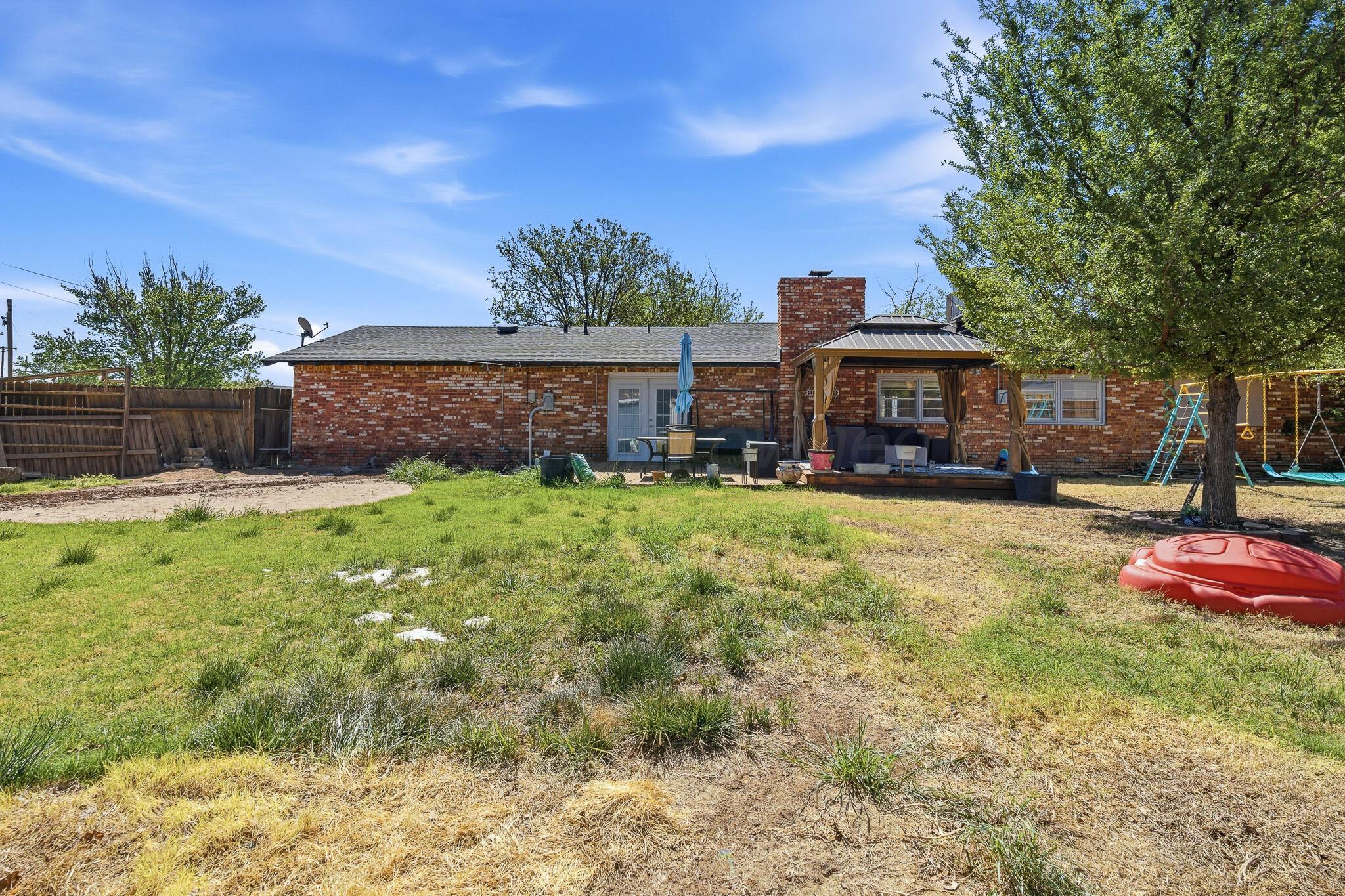 700 West Cleveland Street Dimmitt, TX 79027 - Photo 34 of 40 a view of a house with a yard and sitting area