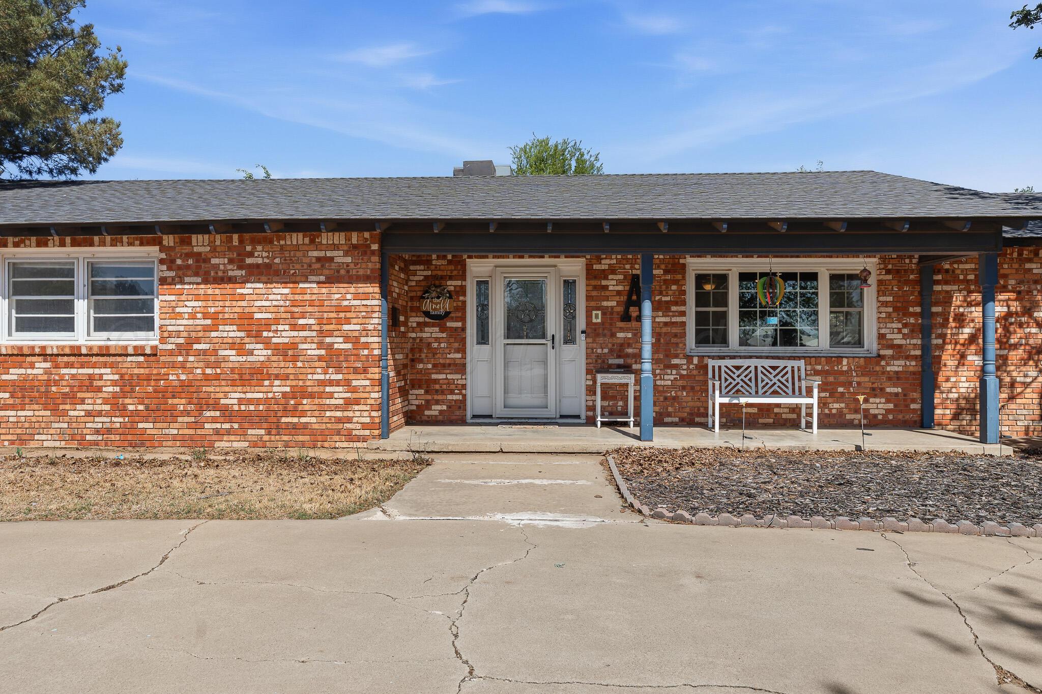 700 West Cleveland Street Dimmitt, TX 79027 - Photo 39 of 40 front view of a brick house with a large window