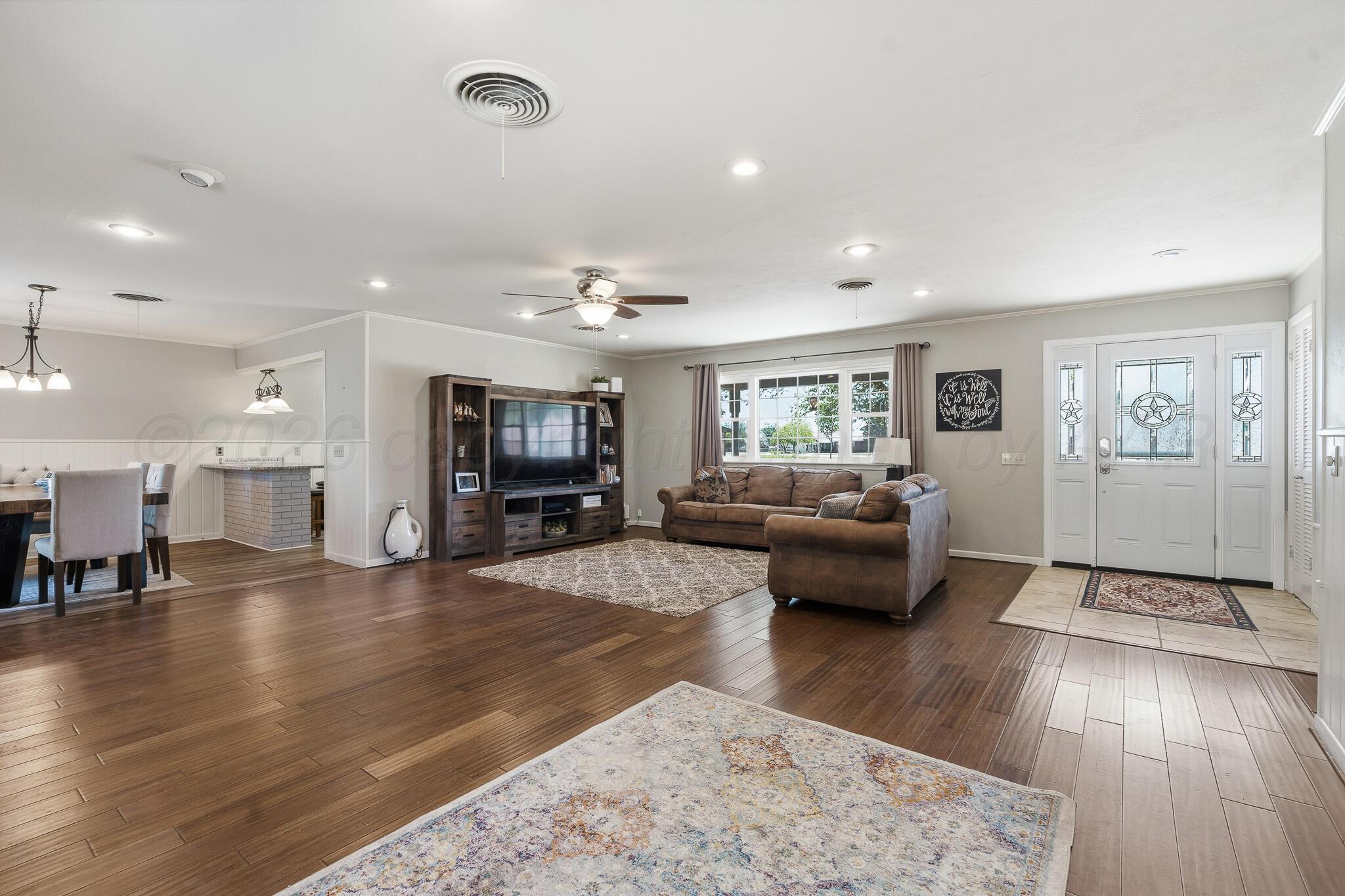 700 West Cleveland Street Dimmitt, TX 79027 - Photo 5 of 40 a living room with furniture and a flat screen tv