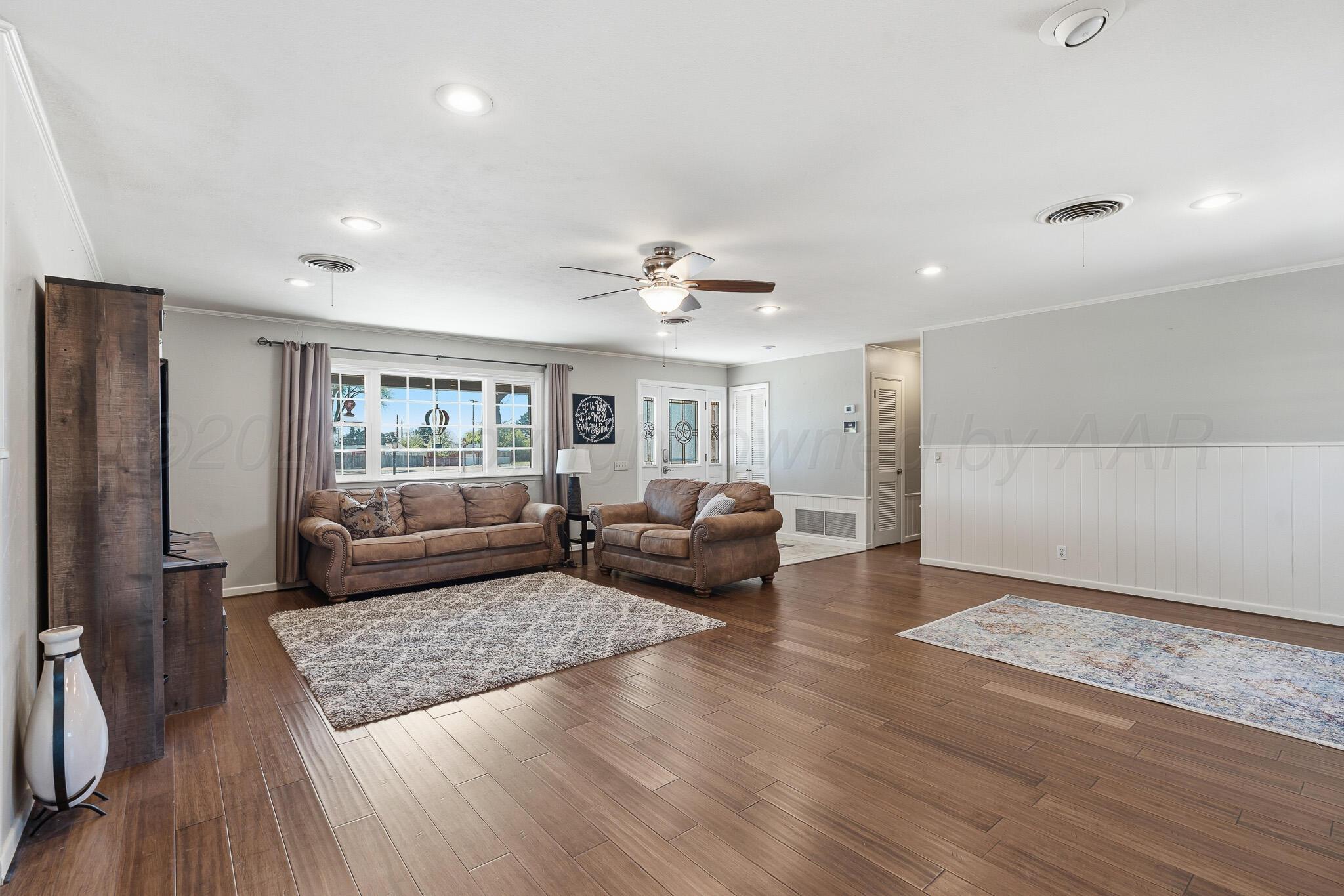 700 West Cleveland Street Dimmitt, TX 79027 - Photo 6 of 40 a living room with furniture and a wooden floor