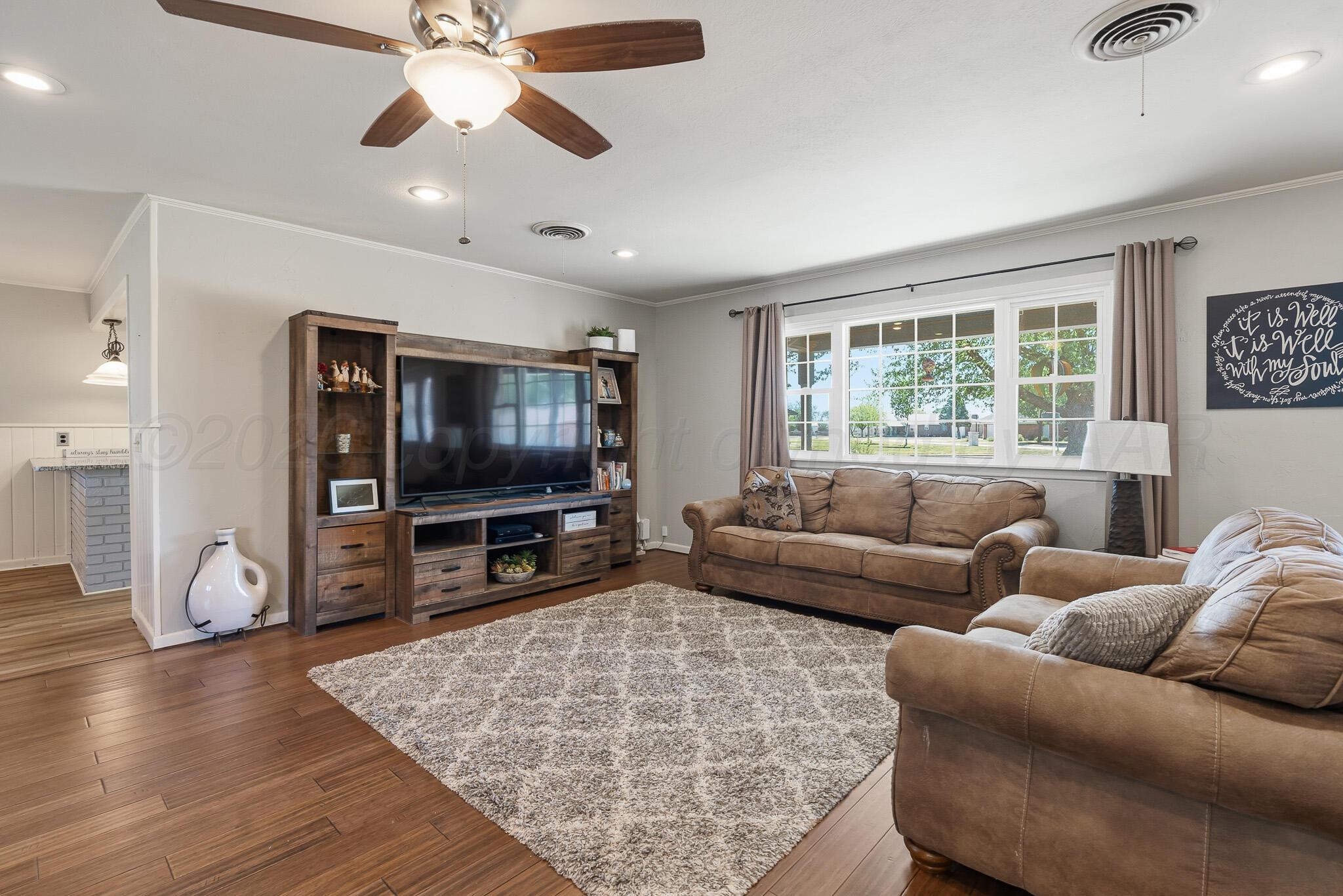 700 West Cleveland Street Dimmitt, TX 79027 - Photo 7 of 40 a living room with furniture and a flat screen tv