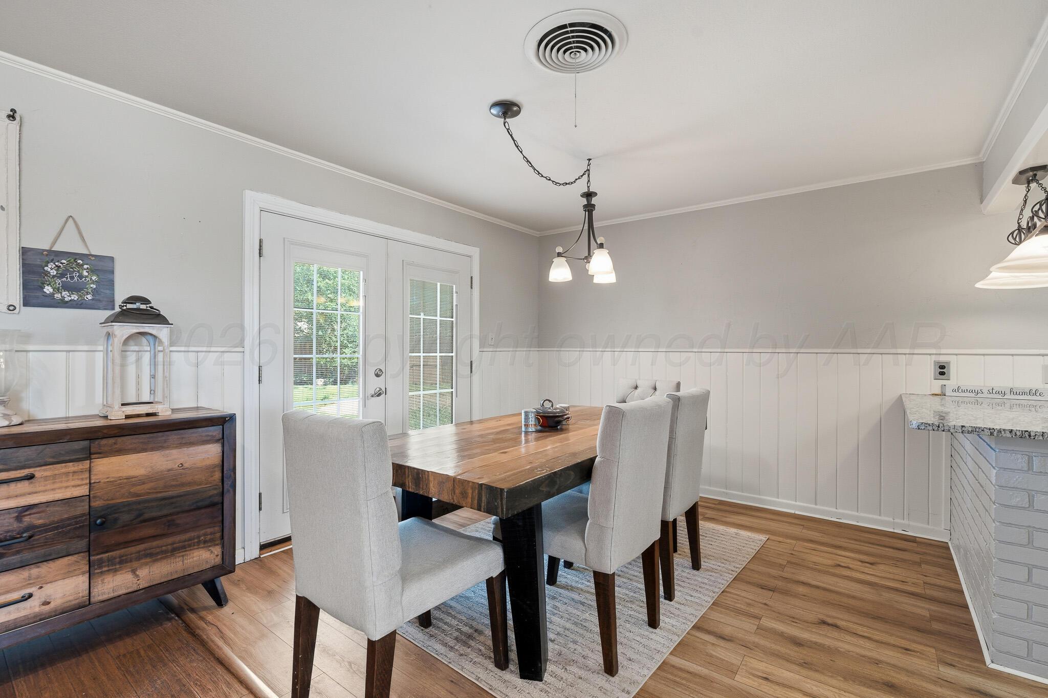700 West Cleveland Street Dimmitt, TX 79027 - Photo 9 of 40 a view of a dining room with furniture and wooden floor