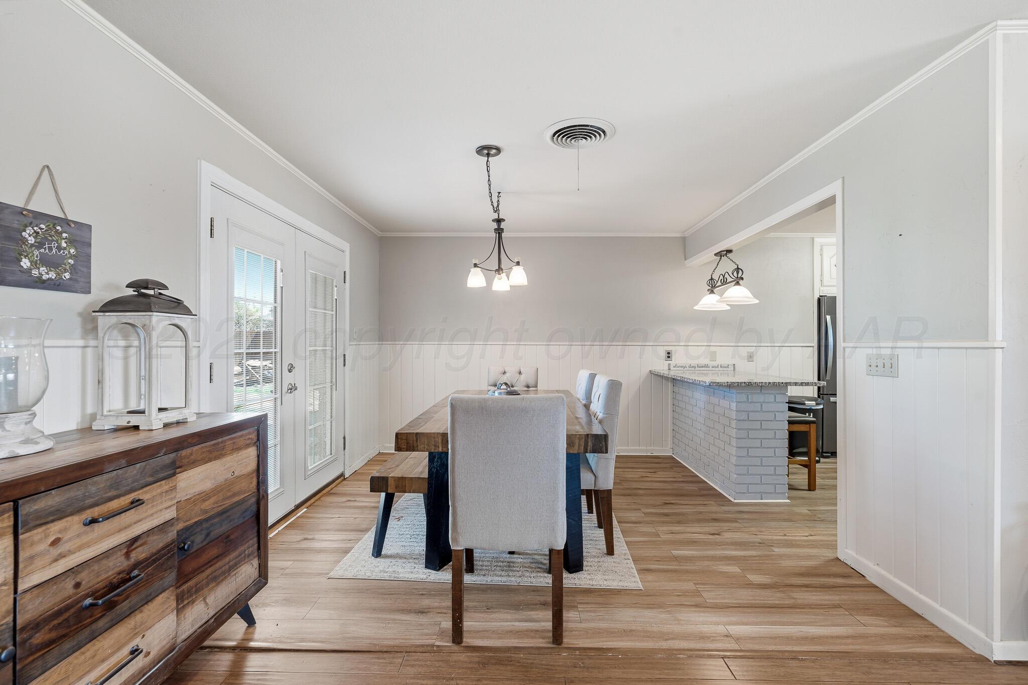 700 West Cleveland Street Dimmitt, TX 79027 - Photo 10 of 40 a view of a dining room with furniture window and wooden floor
