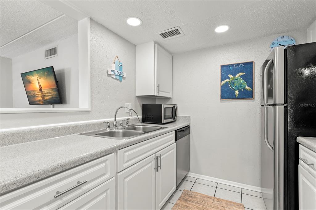 8911 Blind Pass Road, Unit 214 St. Pete Beach, FL 33706 - Photo 11 of 35 a bathroom with a sink and a mirror