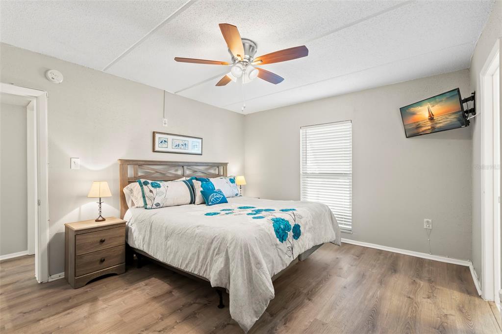 8911 Blind Pass Road, Unit 214 St. Pete Beach, FL 33706 - Photo 12 of 35 a bedroom with bed and a window