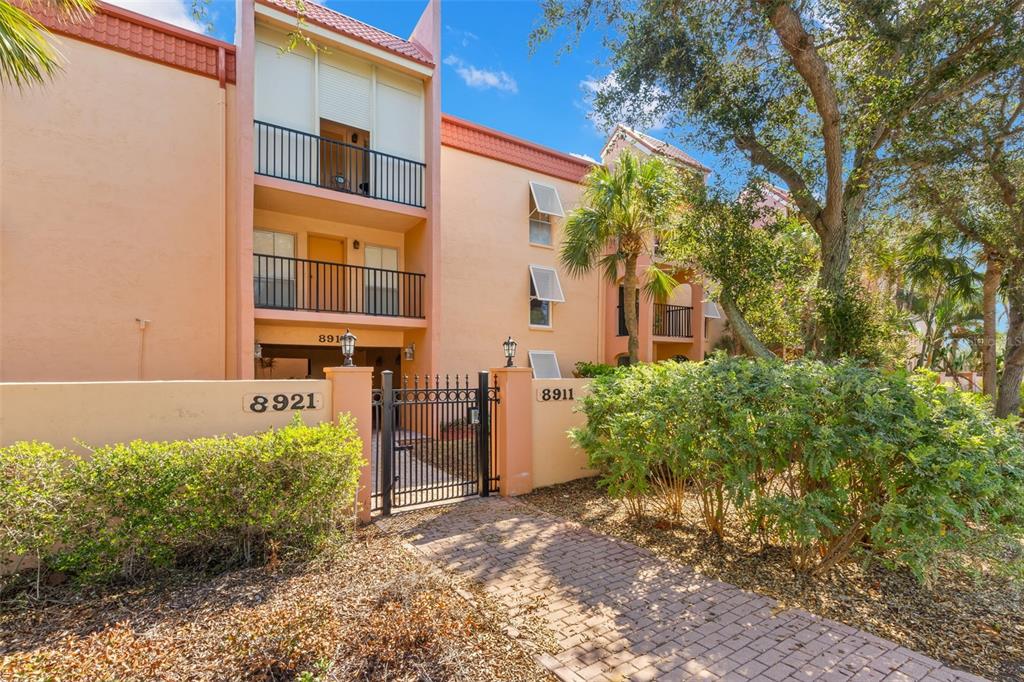 8911 Blind Pass Road, Unit 214 St. Pete Beach, FL 33706 - Photo 19 of 35 a view of a house with a yard