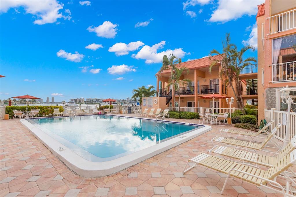 8911 Blind Pass Road, Unit 214 St. Pete Beach, FL 33706 - Photo 24 of 35 a view of a swimming pool and a terrace