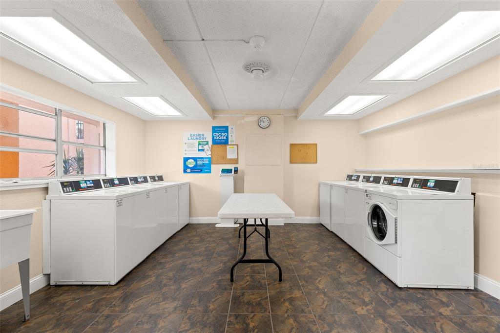 8911 Blind Pass Road, Unit 214 St. Pete Beach, FL 33706 - Photo 26 of 35 a utility room with washer and dryer