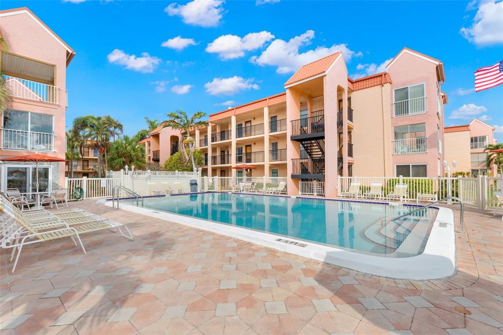 8911 Blind Pass Road, Unit 214 St. Pete Beach, FL 33706 - Photo 4 of 35 a view of a building with a outdoor space