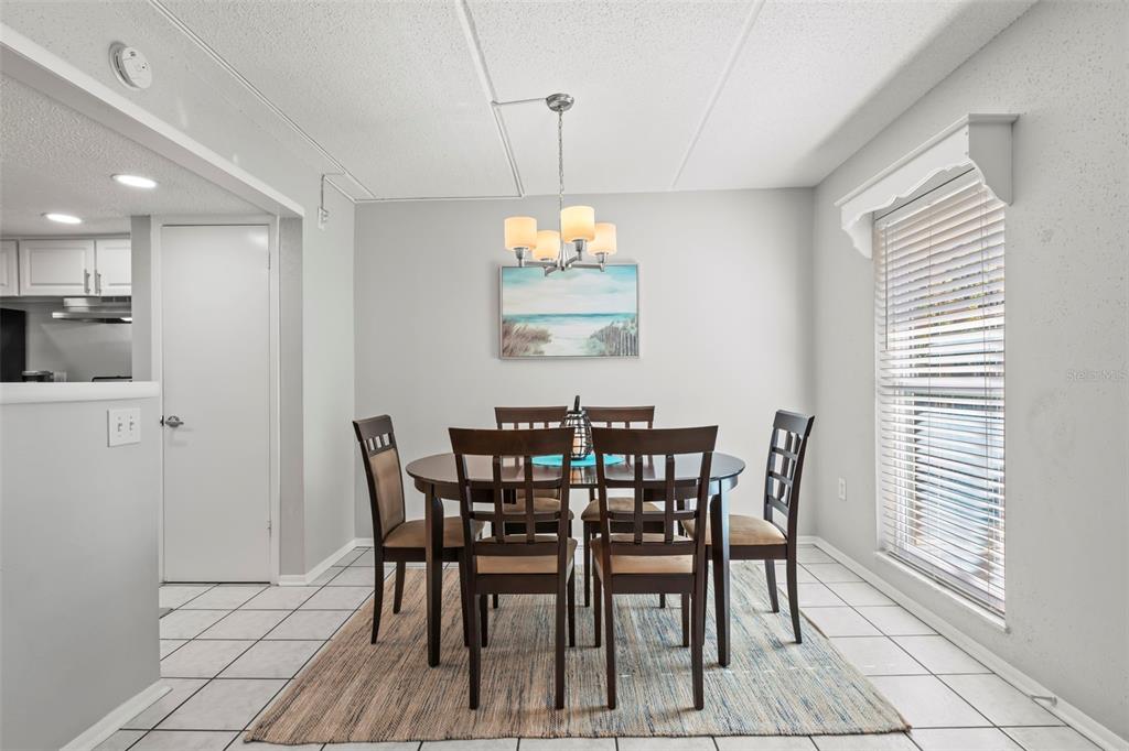 8911 Blind Pass Road, Unit 214 St. Pete Beach, FL 33706 - Photo 7 of 35 a view of a dining room with furniture and window