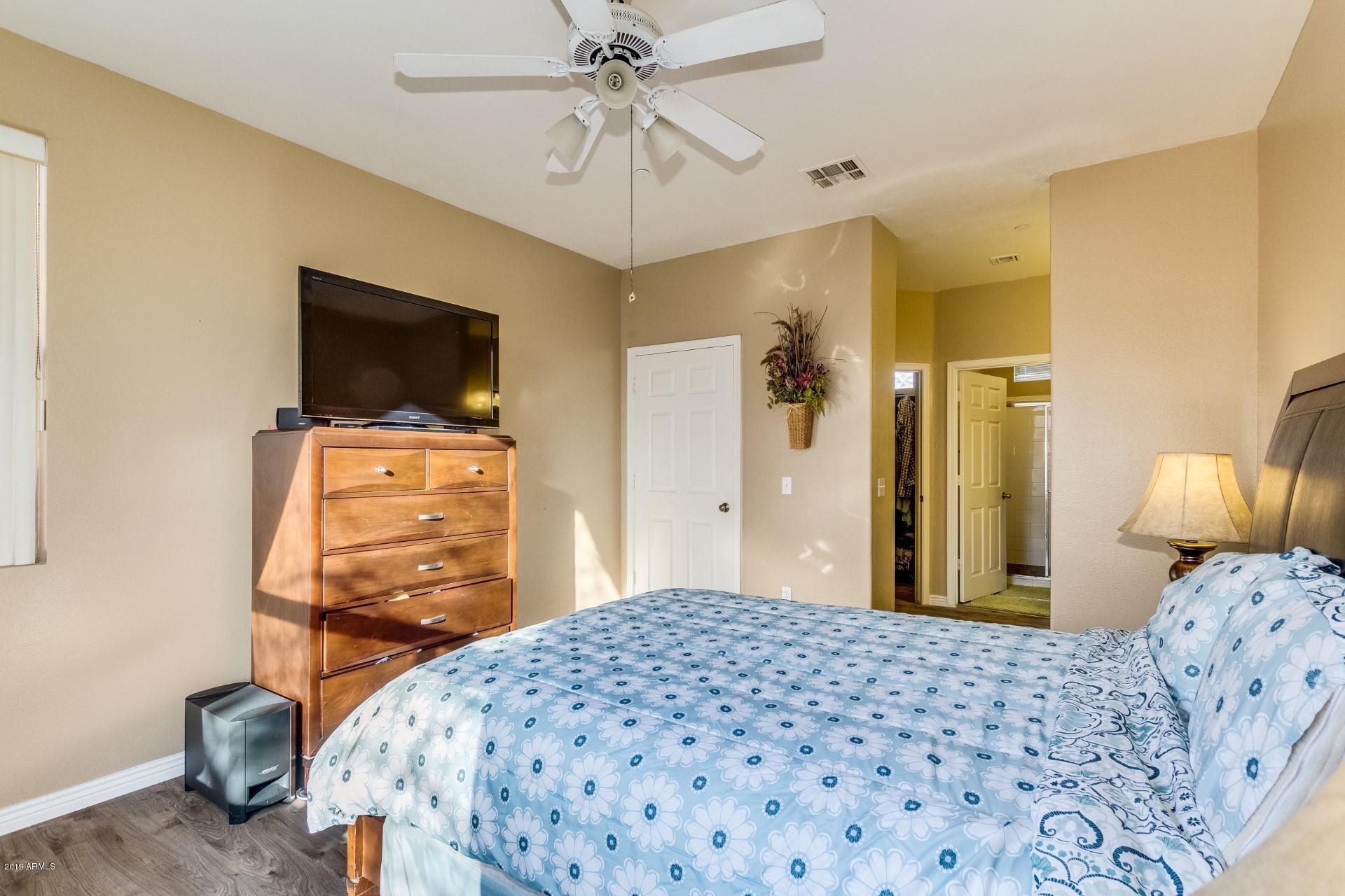 9550 East Thunderbird Road, Unit 252 Scottsdale, AZ 85260 - Photo 12 of 21 a bedroom with a bed and a flat tv screen on dresser