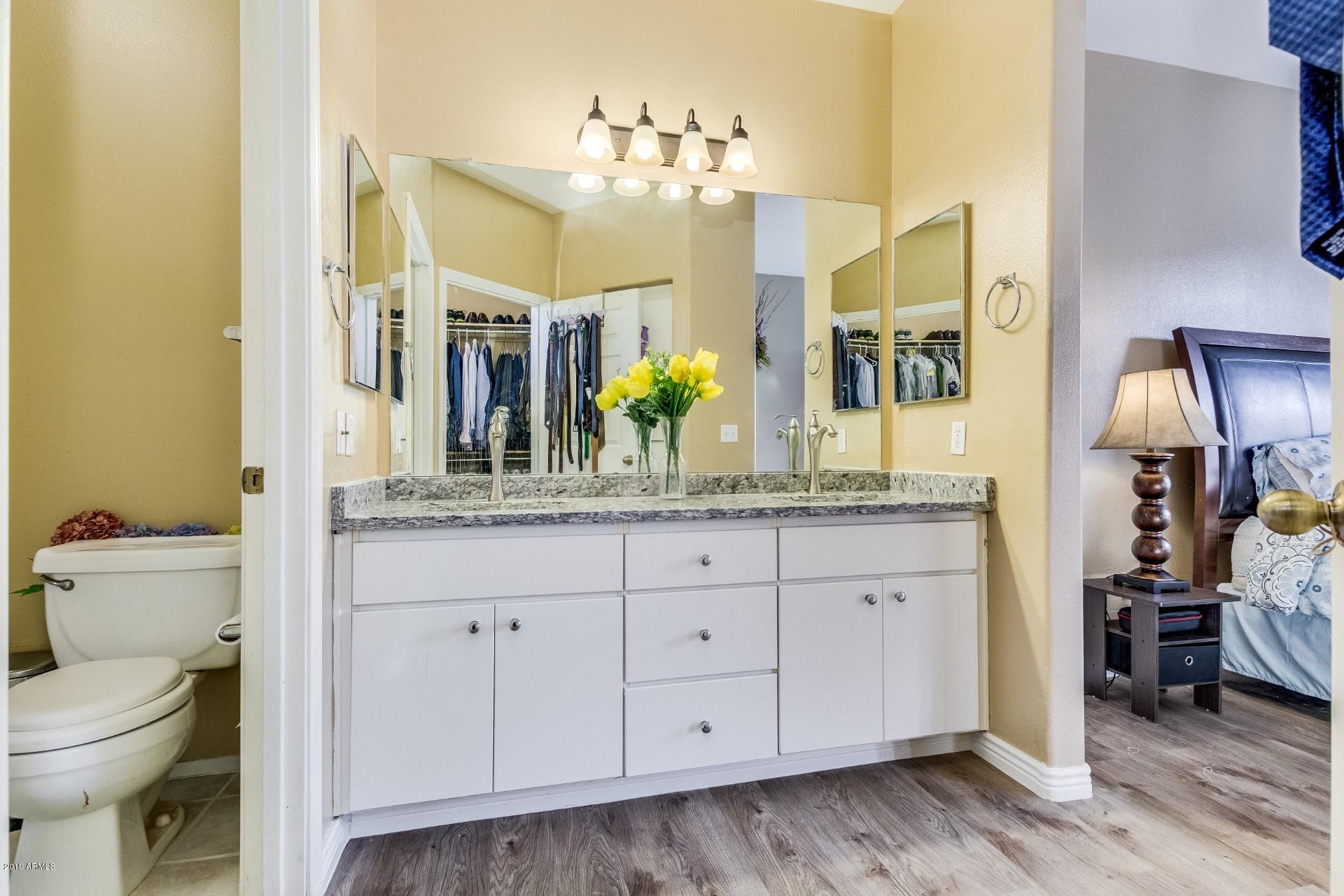 9550 East Thunderbird Road, Unit 252 Scottsdale, AZ 85260 - Photo 13 of 21 a bathroom with a granite countertop sink a toilet and a mirror