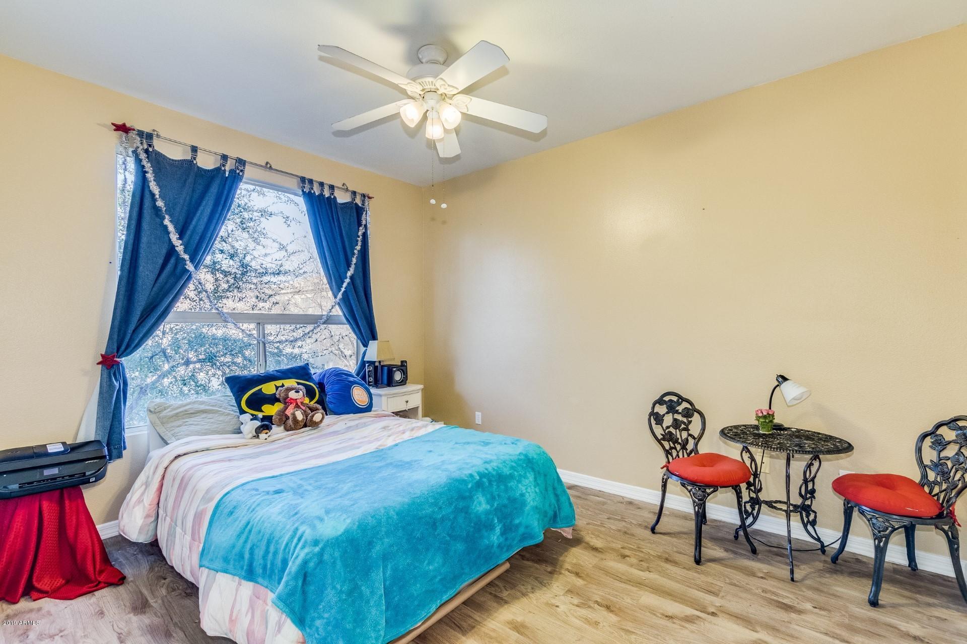 9550 East Thunderbird Road, Unit 252 Scottsdale, AZ 85260 - Photo 9 of 21 a bed sitting in a bedroom next to a window