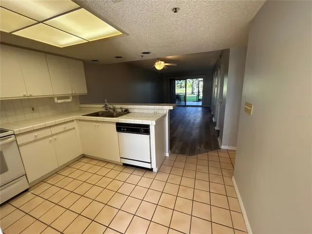 a kitchen with a sink cabinets and appliances