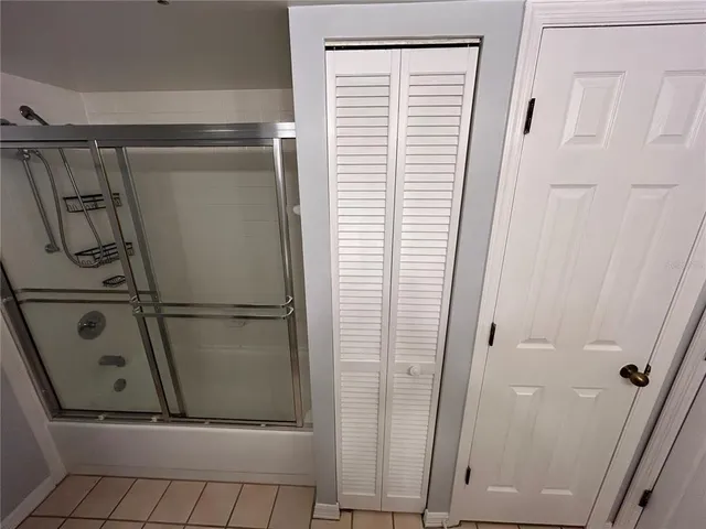 a bathroom with a glass shower door