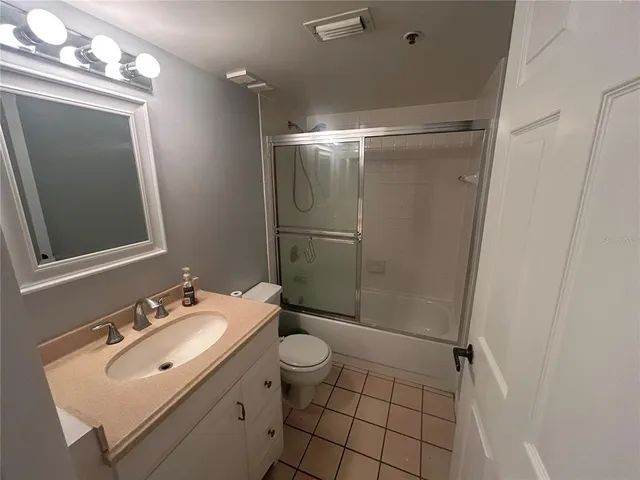 a bathroom with a sink mirror vanity and toilet