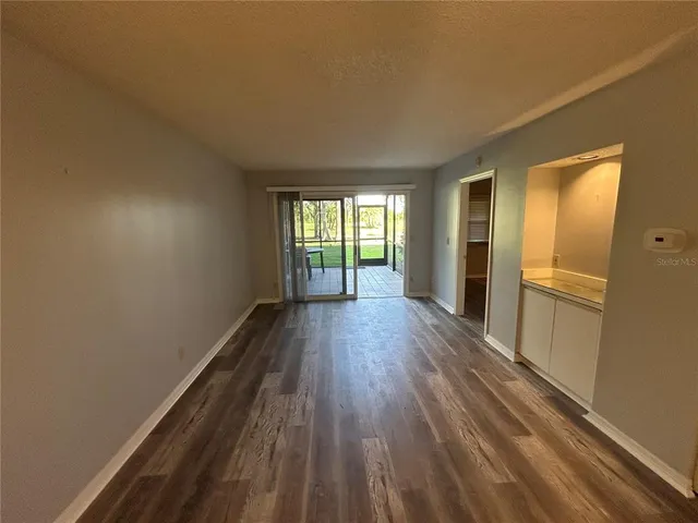 a view of wooden floor and windows in a room
