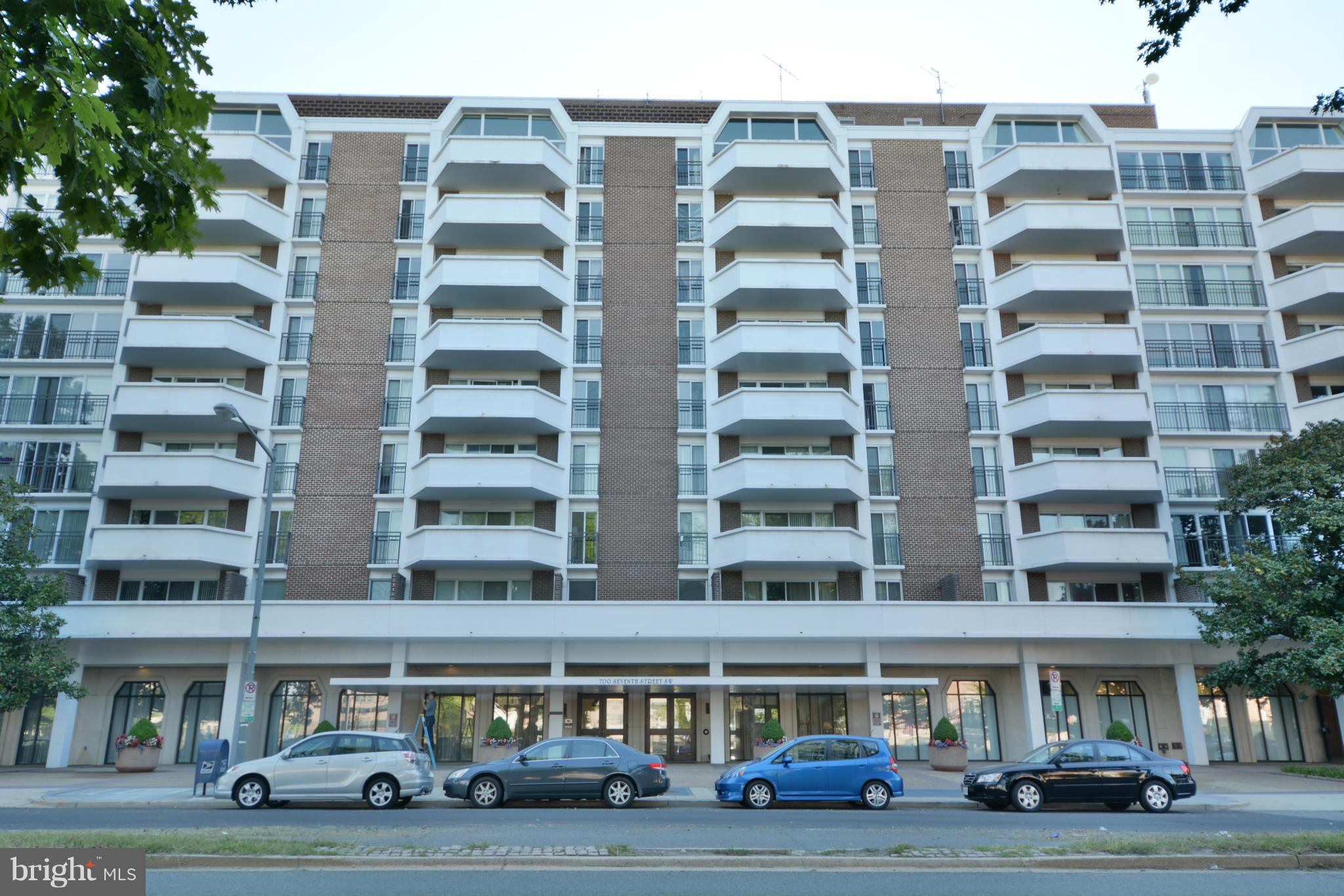 700 7th Street Southwest, Unit 630 Washington, DC 20024 - Photo 1 of 28 a front view of a building with lot of cars and trees