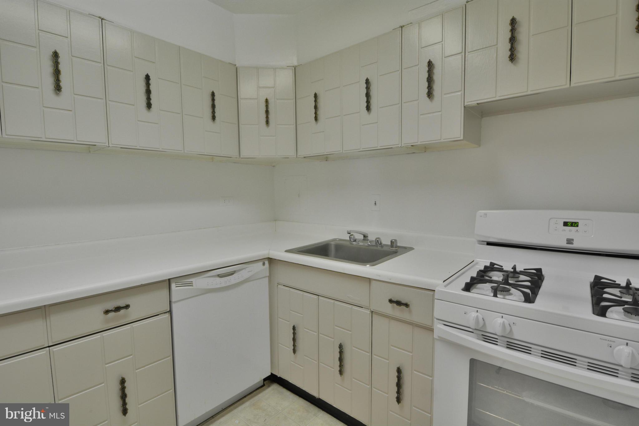 700 7th Street Southwest, Unit 630 Washington, DC 20024 - Photo 11 of 28 a kitchen with white cabinets and white appliances